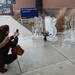 Beth Ryan documents her ice carving proposal from boyfriend William Collins outside of the Kellogg Eye Center on Thursday, Feb. 14.  Melanie Maxwell I AnnArbor.com